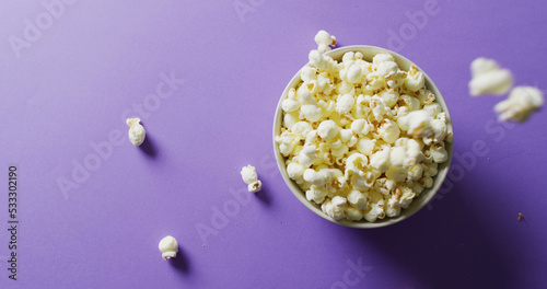 Image of close up of popcorn on purple background