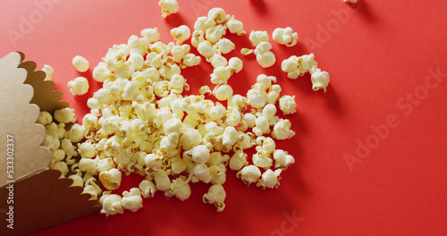 Image of close up of popcorn on red background