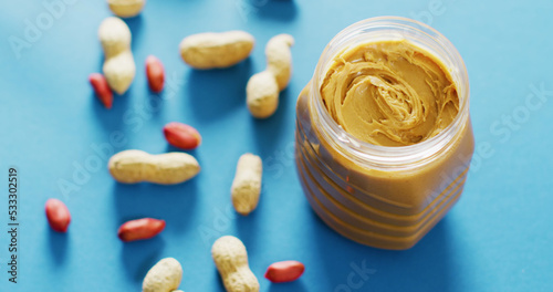 Image of close up of peanut butter on blue background