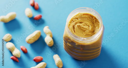 Image of close up of peanut butter on blue background