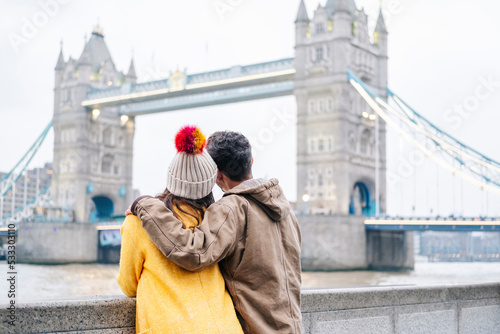 London, United Kingdom, Couple looking at Tower bringe with arms around photo