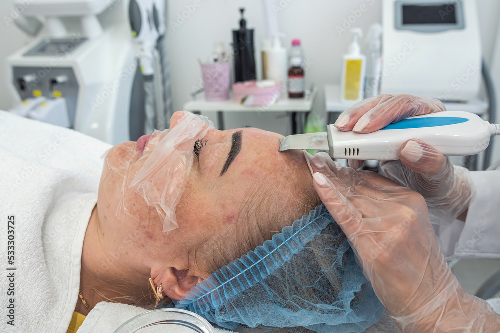 view of making a moisturizing nourishing mask for a client's face in a beauty salon. view of making a moisturizing nourishing mask for a client's face in a beauty salon.