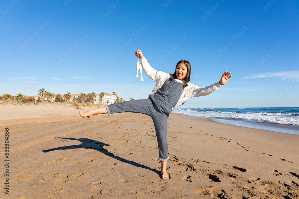 Happy girl enjoying with artificial fish toy at beach Happy girl enjoying with artificial fish toy at beach