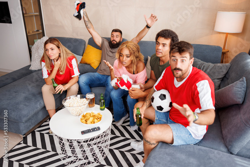 Friends watching football disappointed after their team missing the goal