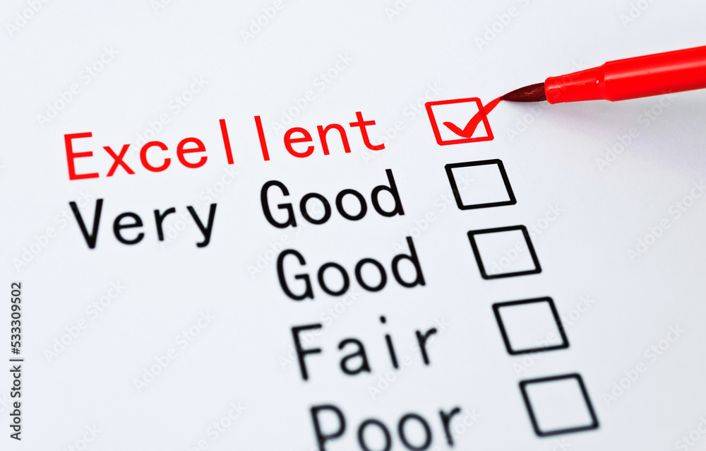 Pen checking the word Excellent in a survey Pen checking the word Excellent in a survey