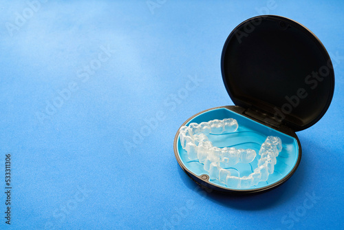 Transparent invisible dental aligners or braces applicable to orthodontic treatment and their containers.