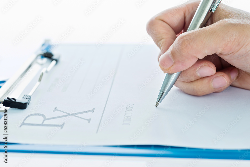Close up of doctor writing prescription paper Close up of doctor writing prescription paper