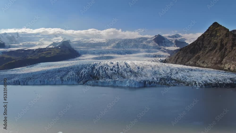 vatnajokull glacier tongue flowing into glacial lake aerial view drone,flying over fjallsarlon lagoon sunny day vatnajokull glacier tongue flowing into glacial lake aerial view drone,flying over fjallsarlon lagoon sunny day
