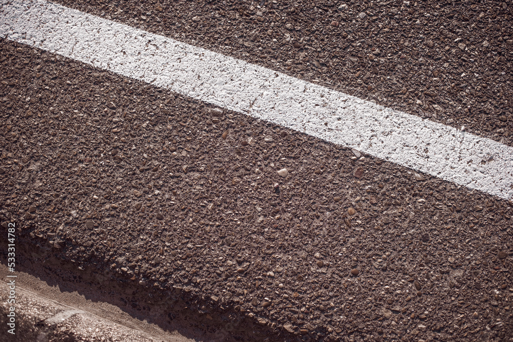 Fototapeta premium Roadside closeup with a white painted line