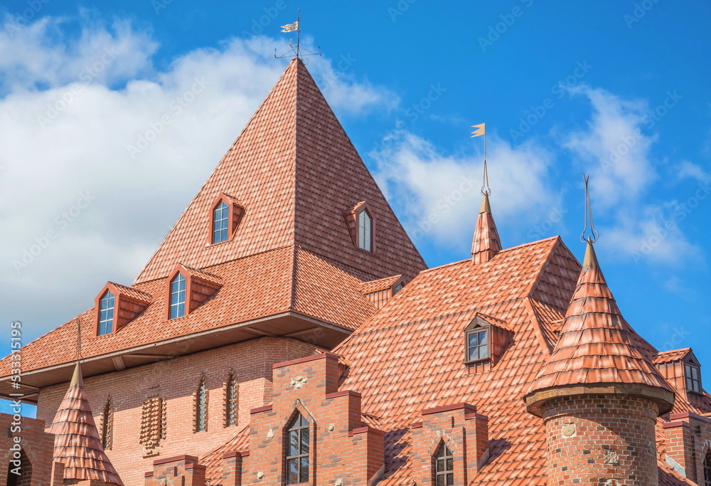 Tiled roof and towers with weathervanes