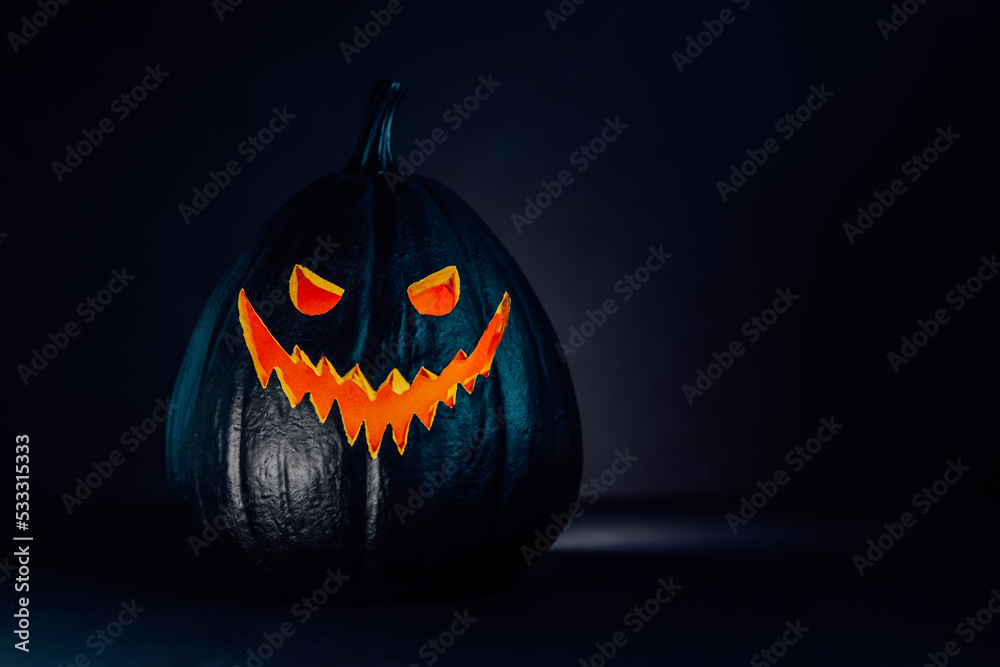 Spooky halloween black pumpkin, Jack O Lantern, with orange illuminated ...