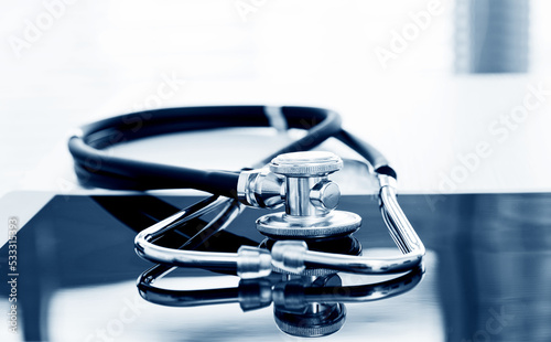 Stethoscope and digital tablet on wooden table