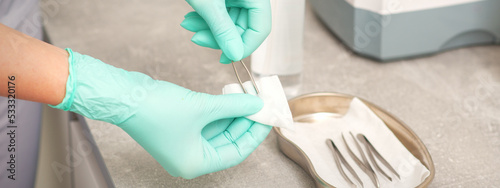 Hand disinfects tweezers with cleaning systems for medical instruments. Ultrasonic cleaner