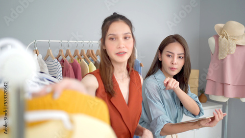 Happy Asian young women making up a dressing room with a beautiful clothes.