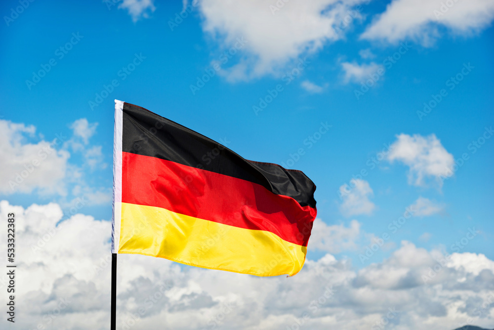 German flag waving against blue sky German flag waving against blue sky
