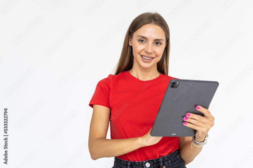 Happy woman using tablet. Smiling woman with tablet pc, isolated on grey background Happy woman using tablet. Smiling woman with tablet pc, isolated on grey background