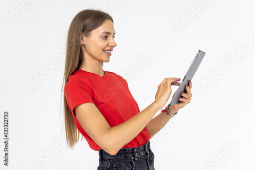 Happy woman using tablet. Smiling woman with tablet pc, isolated on grey background