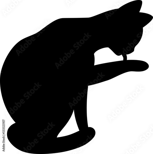 Isolated black silhouette of cat on white background. Flat cartoon sitting cat licks paw.