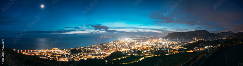 Terracina, Italy. Top View Skyline Cityscape City In Evening Night Illuminations. Panorama, Panoramic View.