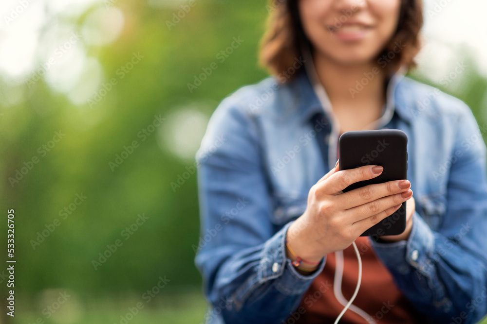 Closeup Shot Of Young Arab Woman Using Smartphone Outdoors Closeup Shot Of Young Arab Woman Using Smartphone Outdoors