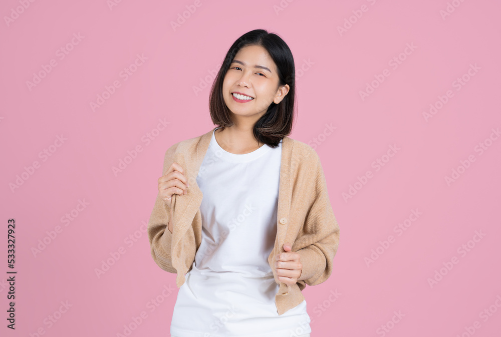 Fototapeta premium Cute asian woman in casual clothes. She is holding a shirt and dancing.