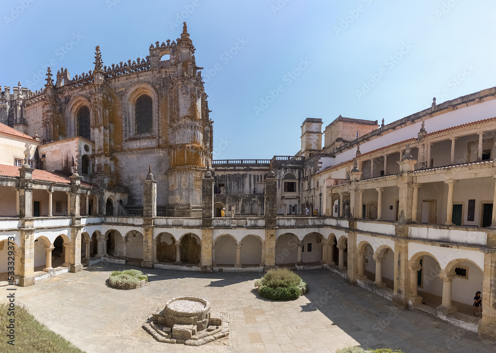 View at the Hospedaria cloister, Lodging cloister, Charola gothic main building as background, tourist people visiting, UNESCO heritage building Convent of Christ, Tomar