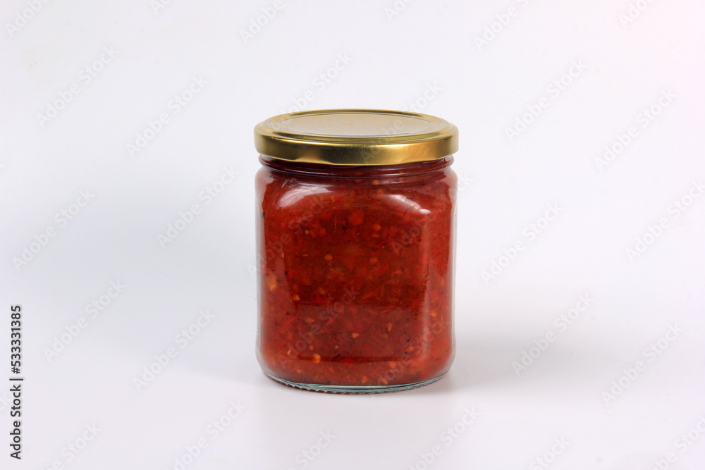 glass jar with boiled red tomato sauce on a white background glass jar with boiled red tomato sauce on a white background