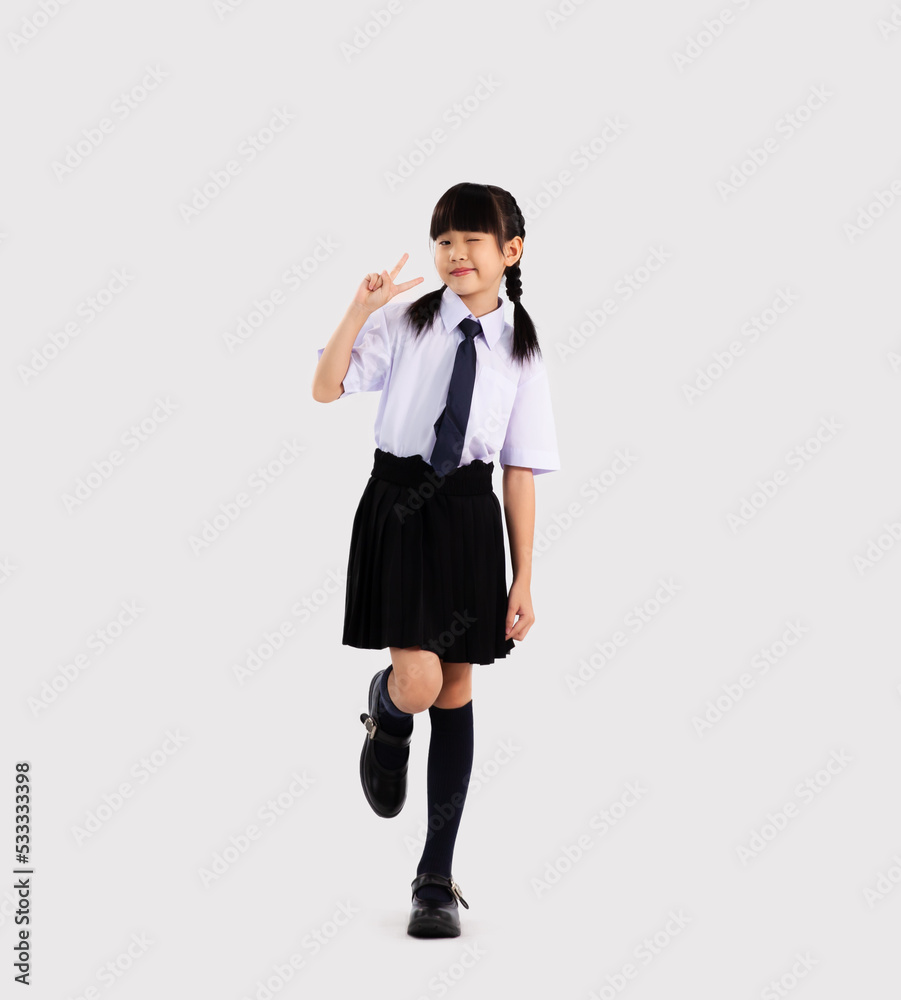 Asian elementary school student kid in uniform posing on white background. Back to school concept. Asian elementary school student kid in uniform posing on white background. Back to school concept.
