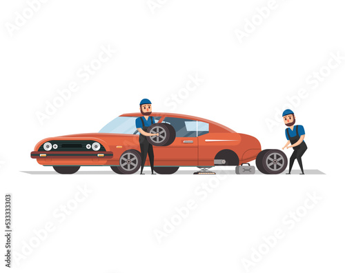 Two professional mechanics in uniform working with red muscle car and replacing the wheel.