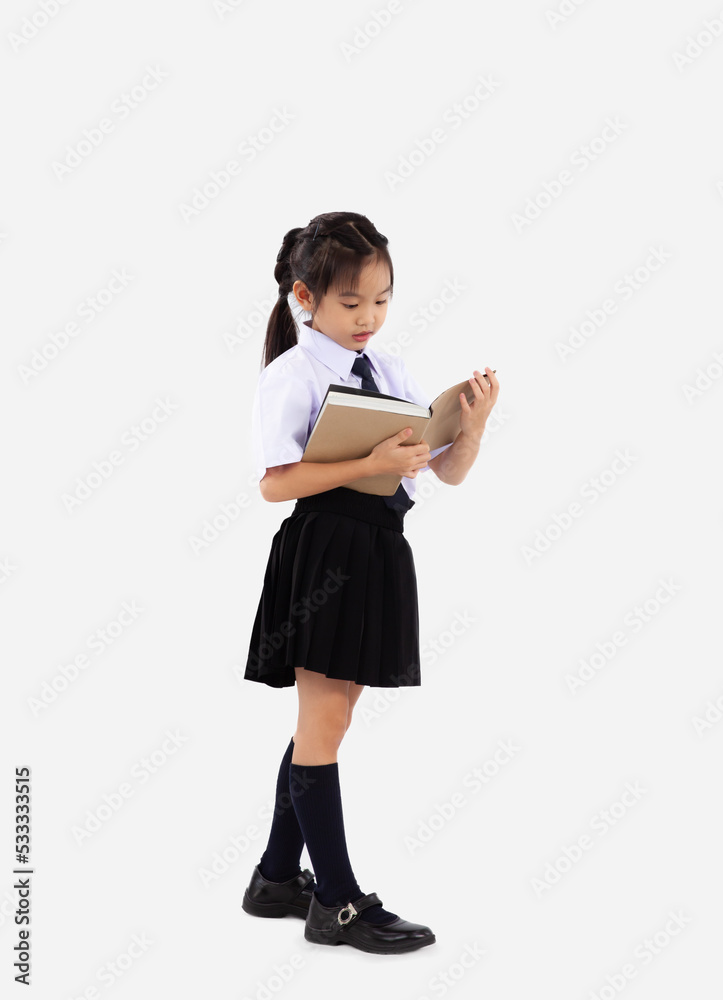 Elemantary school girl in student uniform holding and reading book on white background. Back to school concept. Elemantary school girl in student uniform holding and reading book on white background. Back to school concept.