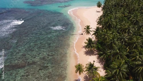 Drone aerial landscape shot of Indian ocean rocky reef sandy beach bay with jungle palm trees beautiful holiday snorkel spot travel tourism Mentawai Islands Sumatra Indonesia Asia 4K photo