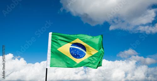 Brazilian flag waving on blue sky