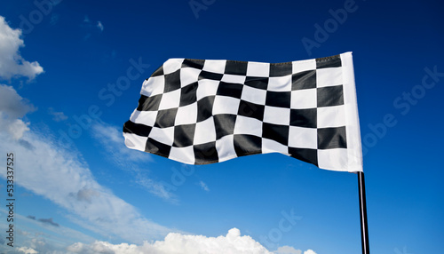 Checkered flag on blue sky