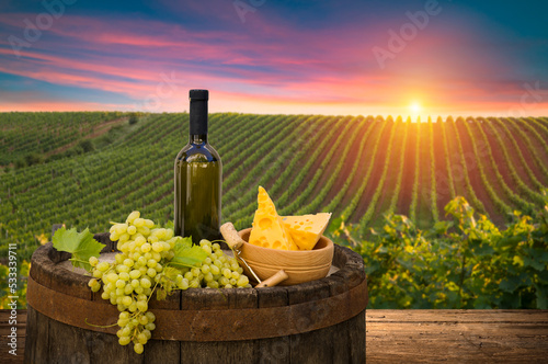 Glass Of Wine With Grapes And Barrel On A Sunny Background. Italy Tuscany With Grapes And Barrel On A Sunny Background. Italy Tuscany Region. High quality photo