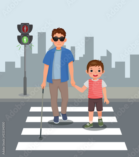 Cute little boy helping blind man crossing street at the pedestrian traffic