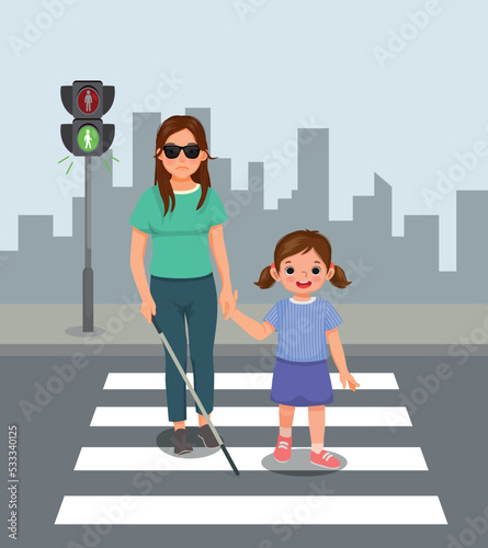 Cute little girl helping blind woman crossing street at the pedestrian traffic