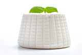 whole ricotta with basil leaf on a white background