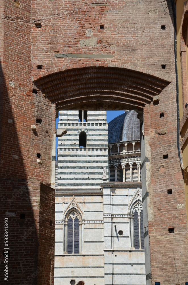 The beautiful countryside and town of Siena in Tuscany on a bright summer day with its typical Tuscan medieval style