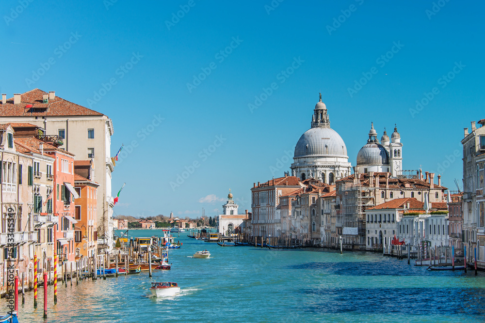 Gondolas and boats sailing down the Grand Canal in Venice. Italy, 2019