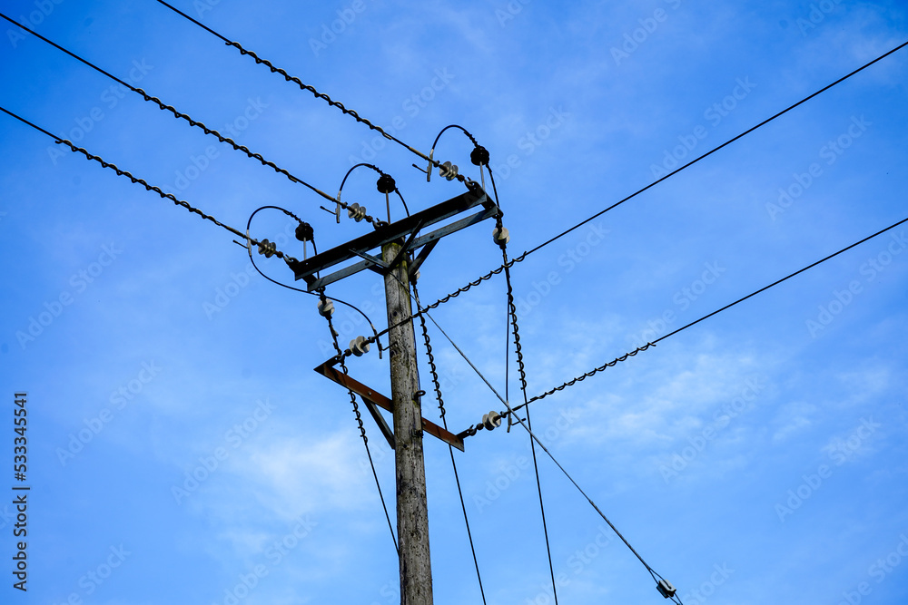 Looking up at power pylons with blue sky and clouds background Looking up at power pylons with blue sky and clouds background