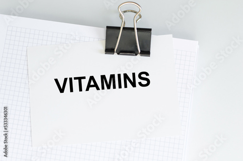 Vitamins text on card, concept background, medicine