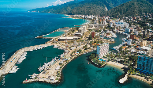 Aerial view of amazing boats at sunset. Top view from the drone of the port with yacht, speedboat and sailboat in Caraballeda, La Guaira, Venezuela. photo