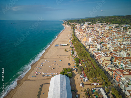 Aerial view of Pineda de Mar beach over fishermen boats beach without people turquoise blue sea