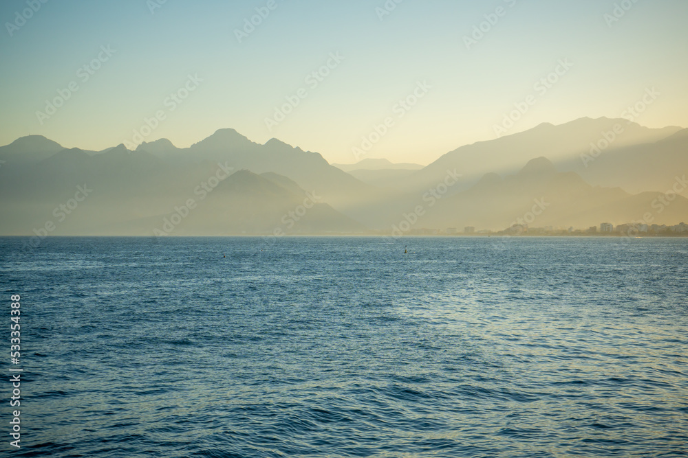 Beautiful landscape of mountains and the Mediterranean sea at sunset light in Antalya, Turkey.