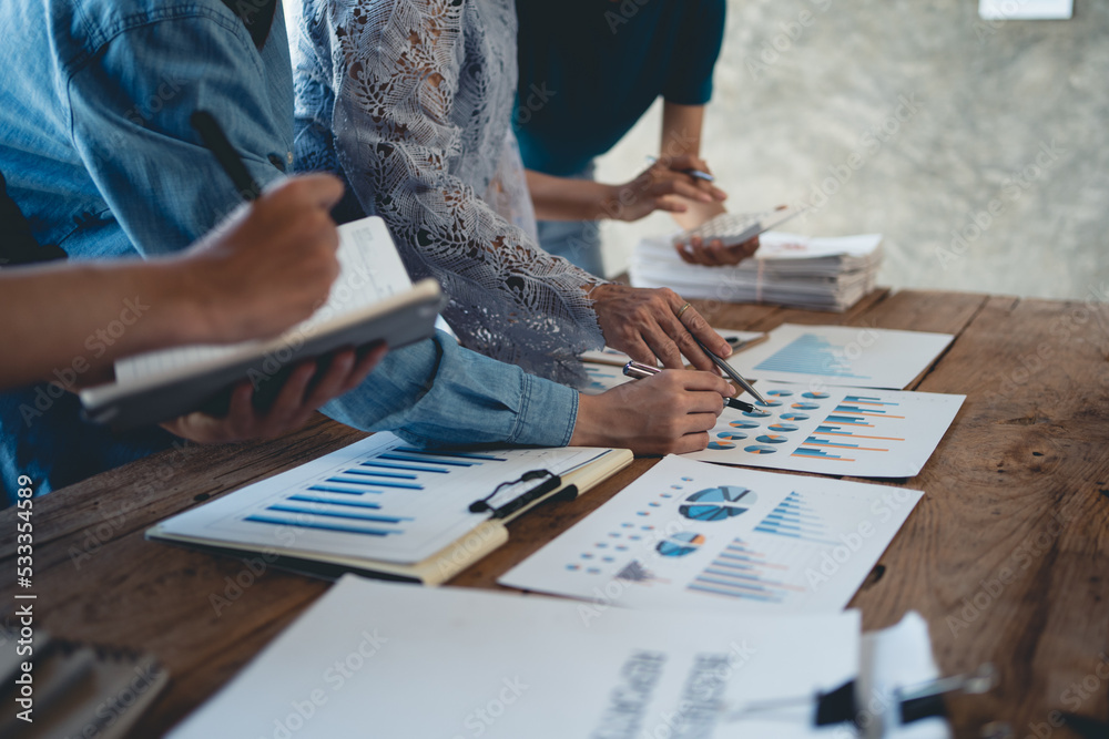 Business people pointing to graph and chart to analyze market, sale, balance sheet, account, net profit data to see the growth of the organization and to develop product. Business people pointing to graph and chart to analyze market, sale, balance sheet, account, net profit data to see the growth of the organization and to develop product.