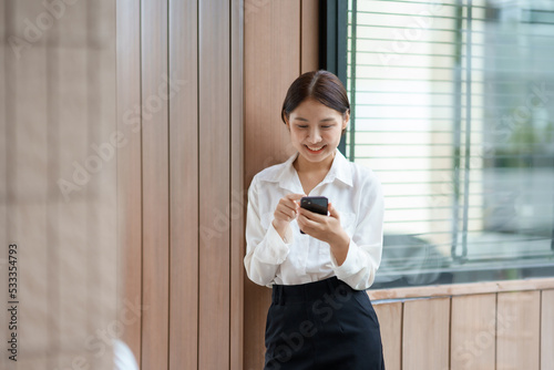 Free Download Attractive young Asian woman using mobile phone in the cafe. - GFXLoad