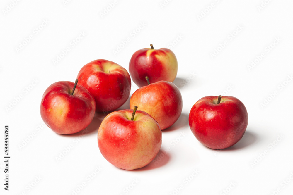 Organic red-yellow small apples on a white isolated background Organic red-yellow small apples on a white isolated background
