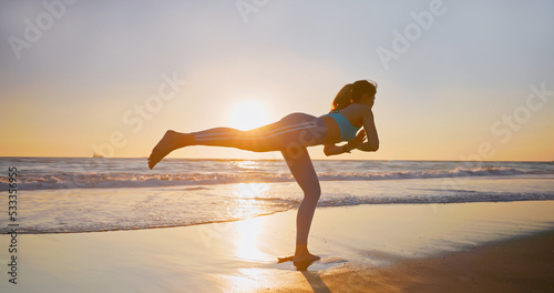 woman practice yoga on beach