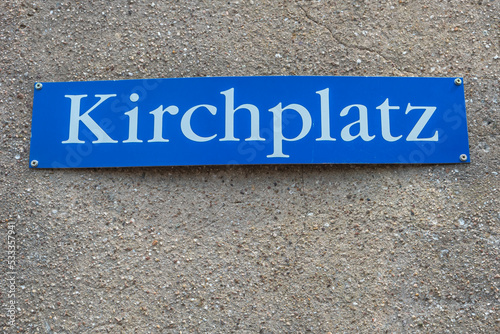 View over an old wall street name plate saying in German Church Square in Germany.