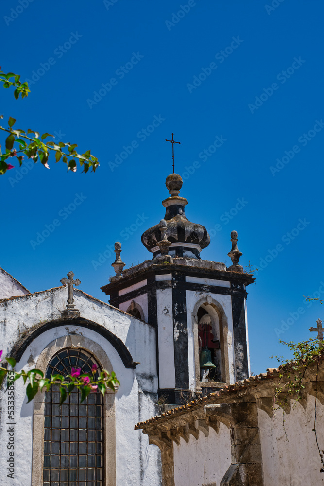Obraz premium Óbidos is one of the most beautiful and picturesque towns in Portugal, which is surrounded by its impressive walls and dominated by its imposing castle